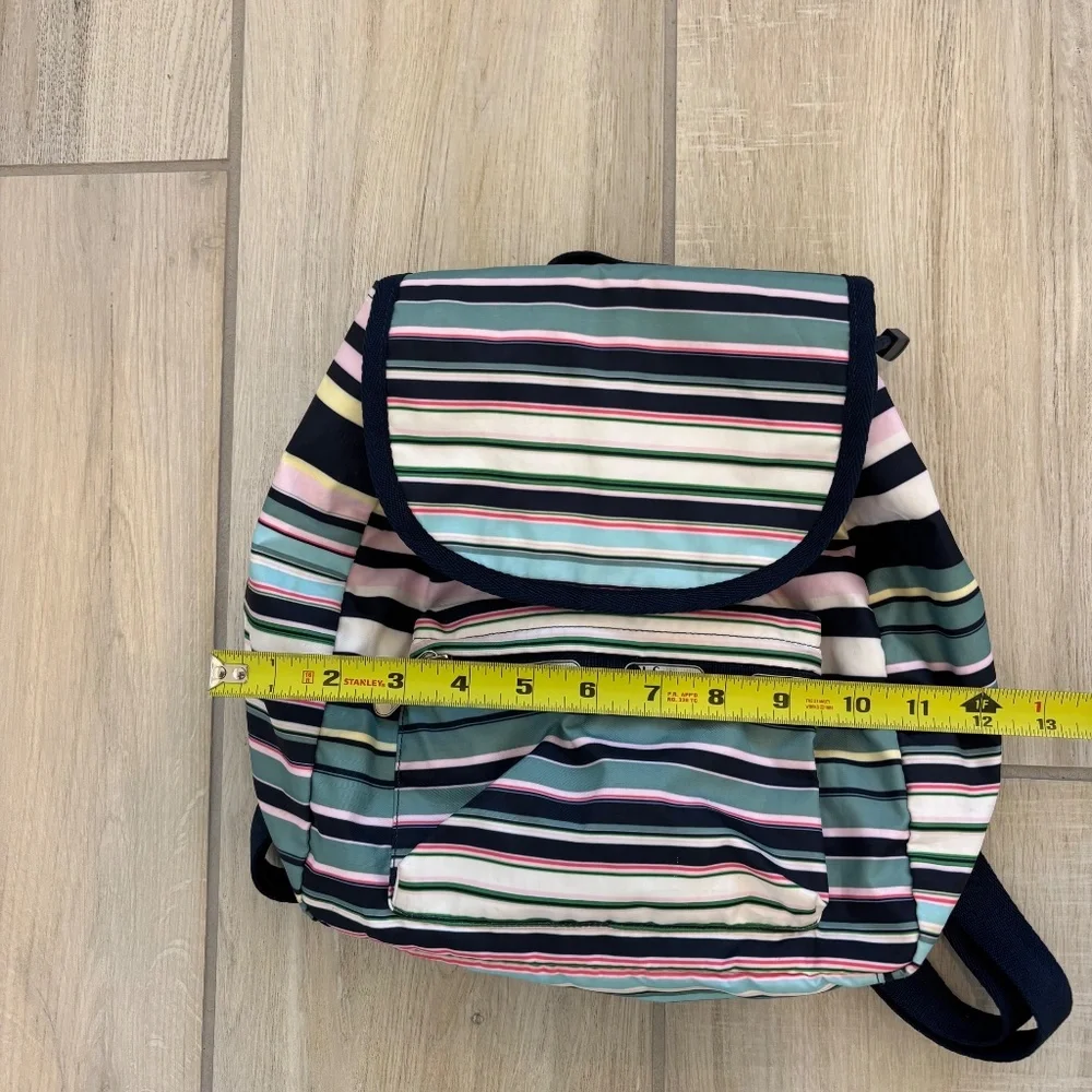 LeSportsac Voyager drawstring backpack in a navy pastel stripe pattern.